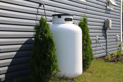 Large 250-Gallon Propane Tank Installed Aside Residential Home Ceiling Alternatives, Propane Heater, Sources Of Heat, Plumbing Installation, Apartment Aesthetic, Tiny House Cabin, Diy Flooring, Linear Lighting, Propane Tank