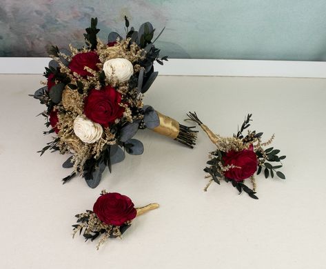 Winter wedding arrangements made of sola flowers, dried flowers, and preserved eucalyptus. Soft wooden flowers in deep red, gold and ivory, with gold painted dried flowers and preserved eucalyptus greenery. Stems with satin ribbon. Smells wonderful!  Will serve you on your Big Day and a long time after.  MADE ON ORDER Dimensions:  BRIDAL BOUQUET                            height approx. 28 cm(11 1⁄32"),                             diameter approx. 25cm(10") MEDIUM BOUQUET Gold And Red Bouquet, Red And Gold Flower Centerpieces, Wedding Burgundy And Gold, Dark Red Bouquet, Winter Wedding Gold, Wedding Bouquets Red, Medium Bouquet, Ivory Bouquet, Red Bridal Bouquet