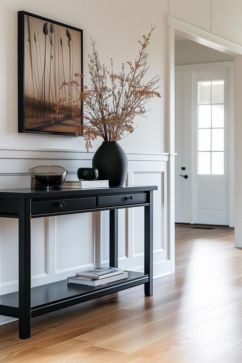 Black console table styled in a modern entryway Entryway Decor Modern Luxury, Apartment Entryway Decor, Entryway Decor Modern, Black Entryway Table, Sofa Table Behind Couch, Modern Entryway Decor, Table Behind Couch, Console Table Entryway, Behind Couch