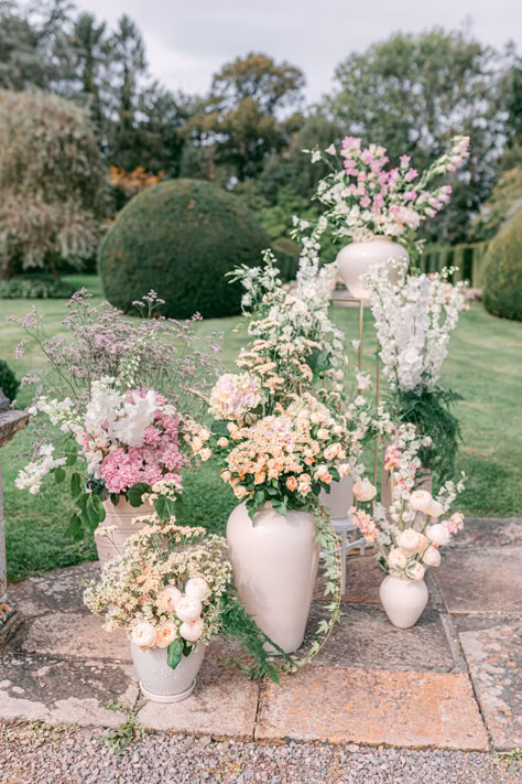 Modern Ceramic Vase Ceremony Backdrop #ceramicvase #weddingvases #weddingcenterpieces #weddingflowers #floralarrangements Large White Vase With Flowers, Wedding Ceremony Urn Arrangements, Wedding Ceremony Vases, English Garden Wedding Ceremony, Romantic Garden Wedding Ceremony, Wedding Urns Ceremony, Wedding Flower Vases, Grounded Florals Wedding Ceremony, French Wedding Flowers