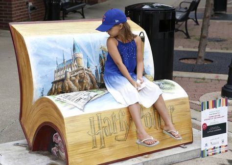 Finley Montague, 7, of Naperville, checks out the imagery of a newly installed book bench in downtown Naperville called "Harry Potter Mystery at the Carillon" by Ken Markiewicz of Crayons Gone Wild. The bench, at Jefferson Avenue and Main Street, is one of 15 such temporary seating spots installed early Friday by the Downtown Naperville Alliance and Naperville public works department. Benches For Outside, Background Hp, Book Bench, Cars Golf, Volunteer As Tribute, Stand Feria, Fantastic Beast, Paddington Bear, Harry Potter Fantastic Beasts