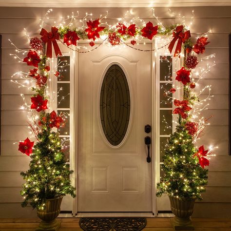 Christmas Door Decorating Ideas - Beautiful Christmas decorations for the porch created using lighted branches and red poinsettias! Diy Christmas Door Decorations, Diy Christmas Door, Outside Christmas Decorations, Christmas Door Decoration, Door Decorating Contest, Diy Christmas Lights, Cheap Christmas Diy, Front Door Christmas Decorations, Lighted Branches