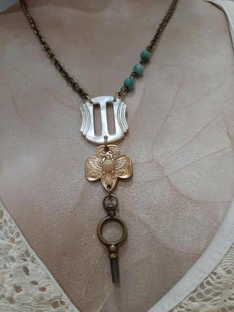 Unique and one of a kind necklace created from a vintage Girl Scout pin (back has been removed and filed smooth), a gorgeous mother of pearl small Art Deco style shoe buckle and a small vintage brass key.  Pendant drop length is 3.25 inches.  Necklace length is 19 inches.  Vintage small link brass chain with lobster claw clasp.  I have added three small teal colored glass beads for a touch of color! Altered Jewelry, Vintage Necklaces, Antique Key Necklace, Belt Buckle Jewelry, Buckle Necklace, Vintage Assemblage Necklace, Washer Jewelry, Upcycled Vintage Jewelry, Pearl Shoes