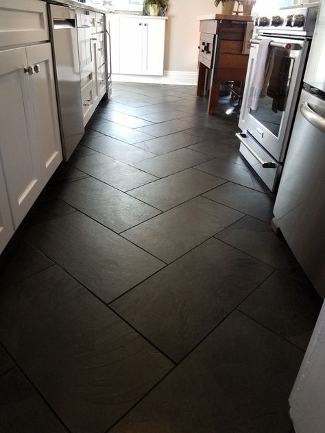 Large Black Floor Tiles, Black Tile Flooring Living Room, Black Tile Living Room Floors, Black Tile In Kitchen, Black Tile Floors Kitchen, Kitchen With Black Flooring, Black Tile Foyer, Black Vinyl Flooring Kitchen, Kitchen Black Floor Tiles