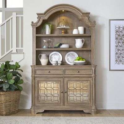 Make entertaining easy and stylish with the Magnolia Manor II hutch and buffet. Crafted with excellence using Poplar solids and Split Heart White Oak veneers, this set features a Weathered Bisque finish. The hutch offers a softly arched shape with dog bone accents and bead moulding. Use the touch LED lighting to illuminate your display on the two wood framed adjustable glass shelves against a planked back panel. Place the hutch on top of the buffet, which features two full extension felt lined d Mirrored Cabinet Doors, Offers Design, Dining Hutch, Lined Drawers, Dining Cabinet, Antique Mirrors, Farm House Colors, Kitchen Sideboard, Small Space Kitchen