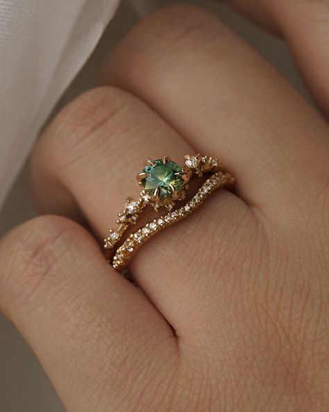 Treasures unearthed from the lush forest floor🌱Shifting with all the colours of verdant treetops against a blue sky, a few recent bespoke blue-green sapphire engagement rings styled with some band options! What is your styling preference? Forest Ring Engagement, Engagement Rings Forest, Colour Engagement Ring, Colourful Engagement Rings, Green Stone Engagement Ring, Green Ring Gold, Wedding Rings Green, Aesthetic Engagement Ring, Green Wedding Ring