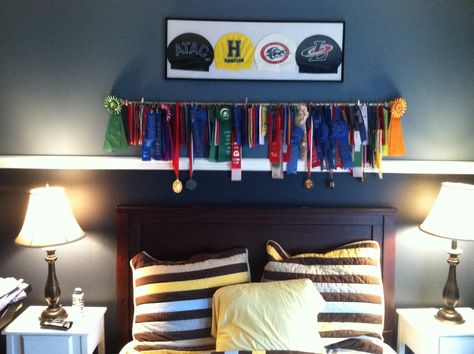 Swimming ribbons and medals hung on a brushed nickel drapery rod.  Framed swimming caps. Swim Themed Bedroom, Displaying Medals, Swim Ribbons, Swimmers Life, Bat Cave, Cap Display, Swimming Cap, Boys Rooms, Teen Boy Bedroom