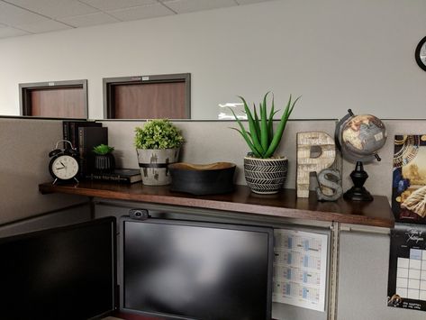 Simple shelf brackets from hardware store with red oak board stained in dark walnut and various shelf decor items. Office Shelf Decor Workspaces, Bank Teller Desk Decor, Work Office Shelf Decor, Boho Cubicle Decor Office, Cubicle Shelf Decor, Diy Cubicle Shelf, Dark Desk Decor, Zen Cubicle Decor, Simple Cubicle Decor