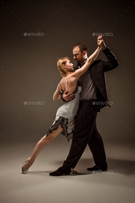 The man and the woman dancing argentinian tango by master1305. A man and a woman dancing argentinian tango on gray studio background#dancing, #argentinian, #man, #woman Couple Dancing Reference, Couple Dance Poses, Dancing Pose Reference, Dancing Reference, Two People Dancing, Argentinian Tango, Dancing Poses, Dancing Pose, Woman Dancing