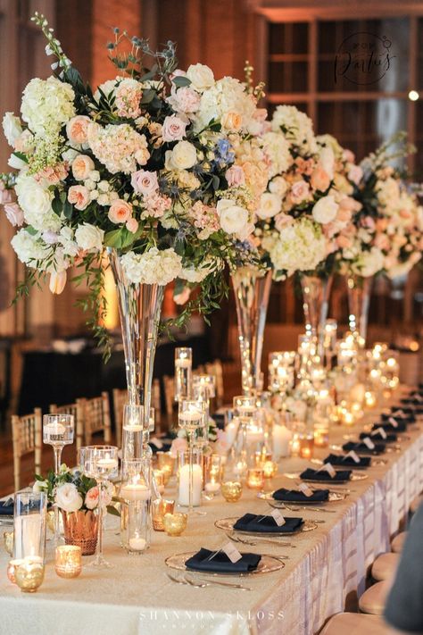 Navy and Peach Wedding, lush floral arrangements, tall floral arrangements, clear glass vases, candle lit table, head table, reception decor, peach and navy floral arrangements, navy napkin, clear gold rimed charger, #dallaswedding #dallasweddingplanner #weddingplanner #luxuryweddings Navy Floral Arrangements, Head Table Reception, Navy And Peach Wedding, Tall Vase Wedding Centerpieces, Tall Wedding Vases, Candle Lit Table, Peach Wedding Decorations, Wedding Table Deco, Head Table Wedding Decorations