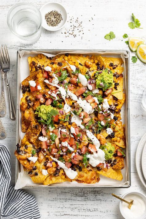 If you haven’t tried prawn nachos before, you’re missing out! These prawn and corn nachos are oven-baked for maximum simplicity, then loaded up with plenty of fresh, tasty toppings. Prawn Nachos, Corn Nachos, Raw Prawns, Sticky Pork, Easy Corn, Sour Cream Sauce, Nachos Beef, Pork Meatballs, Nachos Recipe