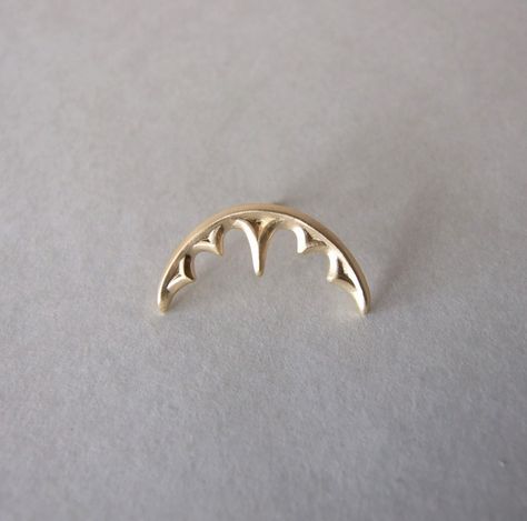 If you're looking for a cool helix earring, that will always attract attention, this is it! It is a single cartilage earring which is inspired by gothic architecture. It is made of gold plated silver and has a nice matte finish. It is held by a hole on the top of the ear and comes with a silver ear backing. I have added a picture ( last one ) with the place of the hole colored in black that fits the piercing. It comes as a single ear piercing, and fits both ears. The length from side to side is Single Ear Piercing, Gold Helix Piercing, Ear Piercing Cartilage, Gold Helix Earrings, Spikes Fashion, New Ear Piercing, Cartilage Helix Piercing, Gold Cartilage Earrings, Helix Jewelry