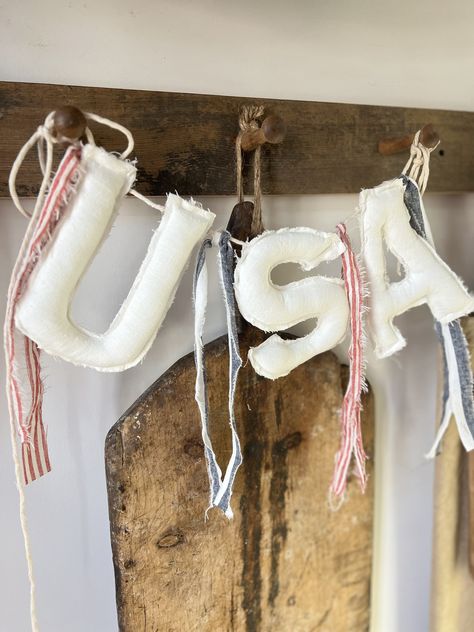 "USA 🇺🇸 ❤️🤍💙 Made from stone washed linens  Each letter is stuffed perfectly for a soft, cozy beautiful banner  There are strips of red/white & blue/white fabric in between each letter.  They are torn and tattered for added texture and charm  So much whimsy too! Each letter had frayed edges  Which I love.  Each letter is about 7\" tall and there is extra bakers twine on each side for hanging  No other accessories included" Memorial Day Decor, Blue White Fabric, Patriotic Banner, Columbia Tn, Letter Banner, 4th Of July Decor, Holiday Room, Blue And White Fabric, July Decor