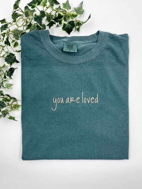 You are loved - Small / Comfort Color T-Shirt T shirt #tshirt t-shirt #t_shirt t shirts #tshirts t-shirts #t_shirts T shirt design #tshirtdesign T-shirt designs #t_shirtdesign T shirts designs #tshirtsdesigns 6.253 Comfort Colors Graphic Tees, T Shirt Embroidery Ideas, Embroidery Shirt Designs, Embroidered Tshirts, Simple Shirt Design, Jesus Clothing, Jesus Clothes, Christian Shirts Designs, Christian Merch