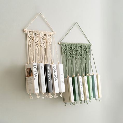 Tis the season to give the gift of reading! Our handmade macrame book holders are the perfect way to show your book-loving friends and family just how much you care. Visit us at https://beandaikon.etsy.com/listing/1716787898 to discover more or reach out to us directly. #BeanDaikon #Macrame #MacrameWallHanger #HandmadeMacrame #HomeDecor #MacrameArt #CraftedWithLove #bookholder #BohemianStyle #HomeStyling #Handcrafted #UniqueDesigns #DecorIdeas #HolidayDecor #UniqueDecor #christmasdecor Macrame Bookshelf, Macrame Book Holder, Wall Hanging Bookshelf, Unique Bookshelf, Macrame Modern, Mid Century Modern Nursery, Hanging Bookshelves, Unique Bookshelves, Nursery Bookshelf