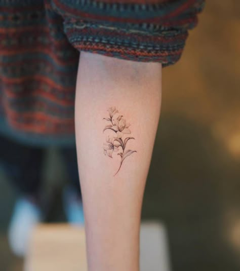 Single needle lily tattoo on the left inner forearm. Elegant Small Tattoos, Tattoos For Ladies, Delicate Flower Tattoo, Lillies Tattoo, Lily Tattoo Design, Lily Flower Tattoos, Daffodil Tattoo, Simple Tattoos For Women, Forearm Tattoo Women