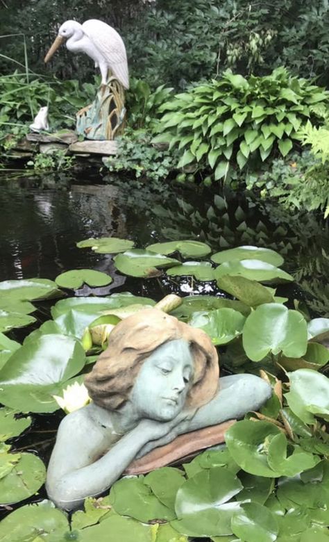 Statue Garden Aesthetic, Statue In Water, Garden Sculpture Ideas, Pond Mermaid, Overgrown Statue Aesthetic, Greek Statue Garden Aesthetic, Lily Pad Sculpture, Goth Garden, Ancient Statues