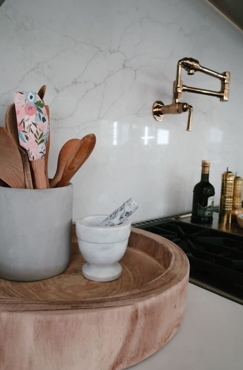 I really like to group my kitchen items on little trays like this. They make things so much more accessible without making your countertop look too disorganized. Shop the look> Gold Salt and Pepper Mills: Wooden Tray: Similar Mortar and Pestle Set: For more on my new kitchen decor, check out my blog>> Carved Tray, Marble Pastry Board, Pastry Board, Salt And Pepper Mills, Beige Marble, Chilli Pepper, Creative Co Op, Cooking Accessories, Kitchen Cooking