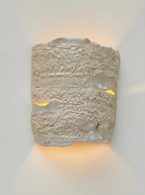 Casa Wall Light No 3 is a stunning piece of artistry, exquisitely designed by Project 213A in 2023. Crafted from artisanal ceramic with a textured finish, each light is meticulously made in Project 213A's own ceramic workshop, ensuring the highest quality and attention to detail. Due to its handmade nature, every piece is unique, with slight variations in shapes and shades that add to its charm and character. This individuality makes each Casa Wall Light No 3 a one-of-a-kind masterpiece, perfect for adding a touch of elegance and sophistication to any space. For those seeking a bespoke touch, custom dimensions and colors are available upon request, allowing you to tailor this exceptional piece to your specific preferences and interior design vision. Handmade in Portugal, the Casa Wall Ligh No Main Light, Ceramic Wall Lights, White Wall Lights, Earthy Aesthetic, Ceramic Workshop, Lampe Decoration, Pottery Inspo, Ceramic Light, Lighting Wall