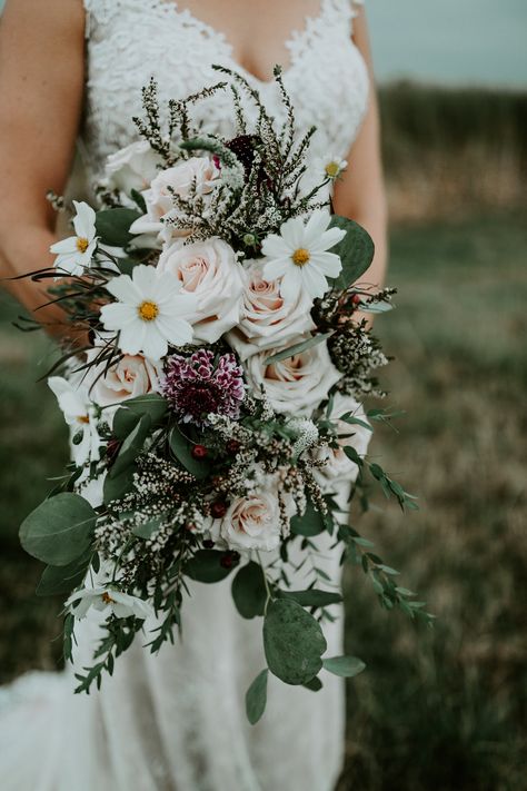 A cascase style bouquet in blush and burgundy tones including quicksand roses, burgundy scabiosa, eucalyptus, white cosmos and calycina. For a western wedding at home near Sheridan, WY created by wedding florist Whirly Girl Flowers. Flower Cosmos, Charming Backyard, Wedding In September, Bouquet With Roses, Silk Flower Wedding, Wedding Home Decoration, Cowboy Wedding, Cascade Bouquet, September Wedding