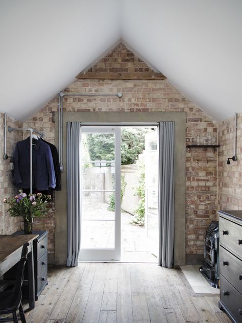 In the back of the garage, new curtained French doors serve as the entrance: A short walk across the terrace leads to the main house. The concrete door surround is a detail Lewis also introduced around the bathroom door. Garage Bedroom Conversion, Garage To Living Space, Garage Floor Paint, Small Bedroom Remodel, Garage Renovation, Garage Room, Garage Bedroom, Interior Design London, Garage Remodel