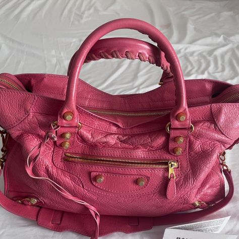 This Beautiful Balenciaga City Bag Is A Must-Have For Any Fashion-Forward Woman. The Exterior Is Made Of Delicate Lambskin Leather In A Stunning Pink Hue, While The Interior Is Lined With Soft Black Cotton. The Bag Features A Classic Satchel/Top Handle Design With A Medium Size, Perfect For Everyday Use. The Bag Also Comes With A Matching Pink Handle/Strap And Mirror Accessory, Adding A Touch Of Elegance To The Overall Look. The Balenciaga Brand Is Known For Its Exceptional Quality And Attention Cute Designer Bags, Balenciaga Bag Outfit, Balenciaga Handbags, Balenciaga Leather, Black Balenciaga, Girls Handbags, City Bag, Balenciaga Bag, Innovative Fashion