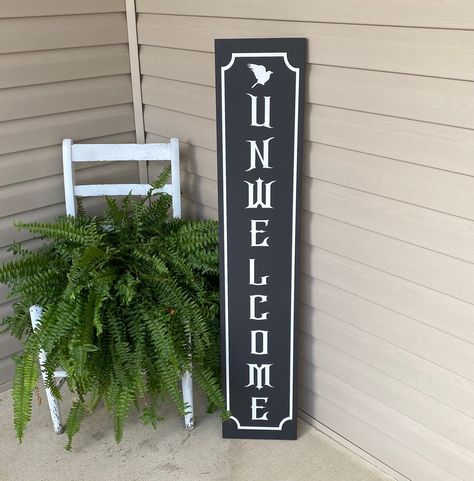 Haunting 'Unwelcome' Sign | Gothic Front Porch Decor Capture the essence of eeriness with our Gothic Unwelcome Porch Sign featuring a haunting raven perched on the letters. Perfect for adding a touch of mystery to your home decor. Get yours today and invite a touch of the dark side to your doorstep. *Available in multiple sizes and colors *Our signs are painted and slightly distressed *Signs vary depending on the grain of the wood and distressing *Real wood has unique imperfections such as bends, knots, and twists *No two signs are the same which gives them a unique quality buyers like *The backs of the signs are not stained or painted *Each sign is made to order so please allow a few days for creating *Intended for indoor use only *All personalized custom sign sales are FINAL *Handmade in Gothic Front Porch, Wooden Porch Decor, Raven Perched, Halloween Porch Decor, Distressed Signs, Wooden Porch, Halloween Porch Decorations, Front Porch Decor, Halloween Sign