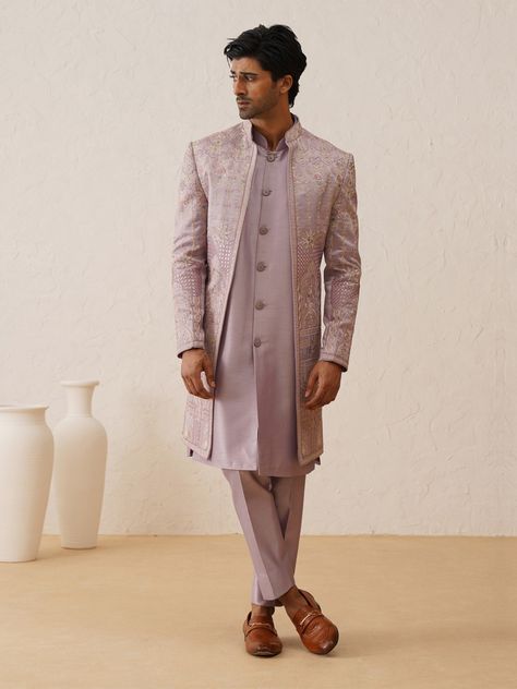 Designed with Resham Multicolor Embroidery this  Indo-Western Sherwani for the Groom and his squad. Crafted from the most luxurious silk, this item will have you feeling like a royal. This indo-western sherwani, including an open sherwani at the front and an inside Jacket paired with slim-cut trousers. Note: Some color variations may occur owing to photography causes. Up to 1 inch of measurement fluctuation is possible. COST INCLUDES SHERWANI,TROUSER & INNER JACKET Lavender Sherwani For Men, Groom Wedding Sherwani, Sherwani For Wedding, Men Sherwani, Engagement Aesthetic, Indowestern Sherwani, Mens Wedding Suits, Sherwani For Men Wedding, Multicolor Embroidery