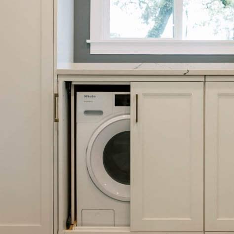 Hide your laundry appliances in a cabinet? This couple had not choice but to put their laundry in their kitchen. So we hid them in these pocket door cabinets so they would look like normal kitchen cabinets when closed. This washer/dryer combo is on the small side... about 3 cu ft instead of the 4 cu ft you get with full size machines. Hidden Laundry Table, Hidden Laundry In Kitchen Cabinets, Hidden Kitchen Laundry, Utility Room Hidden Washing Machine, Dining Room With Laundry Area, Laundry Inside Kitchen, Laundry Next To Kitchen, Washer Dryer Hidden In Cabinet, Washing Machine In Pantry