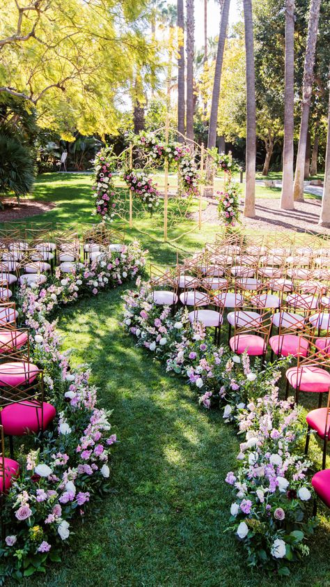 Winding ceremony aisle with pink chairs and spring floral with an enchanted gate as the ceremony backdrop. Dreamy wedding inspiration for an enchanted garden theme. Spring Fairy Wedding Theme, Winding Wedding Aisle, Wedding Isles Ideas Outdoor, Secret Garden Wedding Theme, Enchanted Garden Theme, Fairy Wedding Theme, Wedding Ceremony Aisle, Wedding Aisles, Garden Elopement