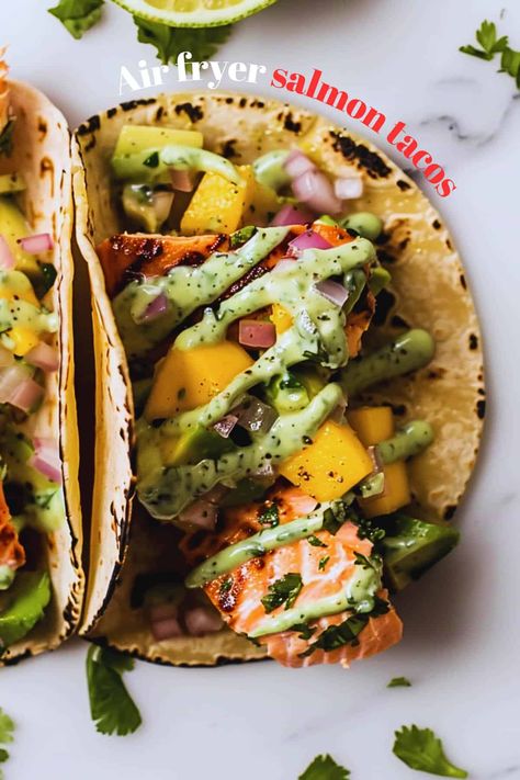 Love quick dinners? You need these air fryer salmon tacos! Perfectly cooked salmon, zesty mango salsa, and so easy. Air Fryer Salmon Tacos, Salmon Tacos Air Fryer, Mango Salsa Recipe Salmon, Salmon Mango Avocado Salsa, Salmon Mango Salsa, Salmon Tacos With Mango Salsa, Salmon With Mango Avocado Salsa, Mango Tacos, Salmon Fish Tacos