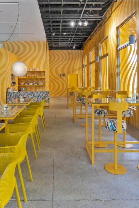 Bringing a dose of maximalism to Miami, Fendi Caffè has opened the doors to its pop-up cafe, revealing a bright yellow interior that’s wrapped in pattern. Located in the city’s Design District, the space is fresh from a total renovation. Photography: Fendi #maximalism #fendi #fendicafe #cafe #miami #interiors #popup #design #interiorarchitecture #yellow #pattern Miami Cafe, Yellow Restaurant, Hotel Hoxton, Pop Up Cafe, Yellow Interior, Yellow Walls, Miami Design, Design District, Pop Up Store