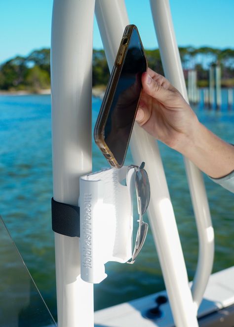 Boat phone holders are the best and a must-have boat accessory and boat gift! The perfect boat accessory for boat owner wanting a hassle-free way to keep their phones available with a secure HOLD and FAST access!  HoldFastPro phone holders area adjustable to a vertical pole.   This patented technology is designed to provide a dual-adjustable phone holder for boats. - Adjust to fit the pole size - Adjust to fit the phone and case - Phone slides in and out effortlessly for FAST access to your phon Boat Hook Storage, Boat Storage Ideas Space Saving, Diy Boat Accessories, Sailboat Accessories, Boat Organization Ideas, Boat Storage Ideas, Boating Hacks, Boat Hacks, Sunglasses Hanger