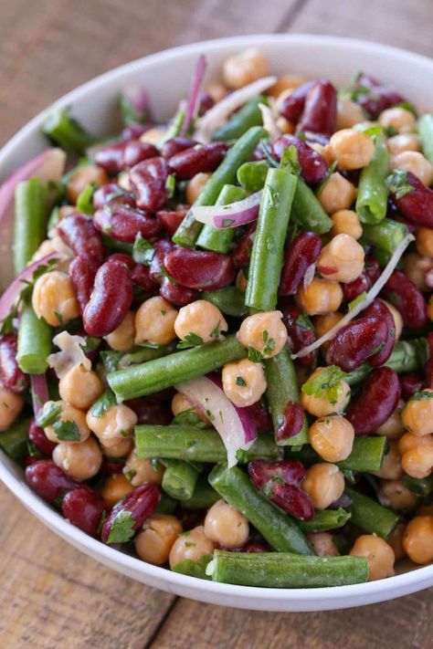 The Classic Three Bean Salad with green beans, garbanzo beans and kidney beans tossed with a sweet and sour dressing is the perfect summer side dish. Three Bean Salad Recipe, Kidney Bean Salad, 3 Bean Salad, Green Bean Dishes, Vegetable Side Dishes Healthy, Bean Salads, Bean Salad Recipe, Coleslaw Recipe Easy, Three Bean Salad