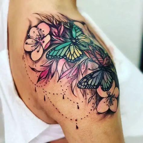 30+ Most Beautiful Flower Tattoo On Shoulder You'll Actually Want Forever Shaded Shoulder Tattoos For Women, Shoulder Tattoo Butterfly Flowers, Shoulder Female Tattoo, Shoulder Cap Tattoos For Women Flower, Female Shoulder Tattoo Ideas, Women Shoulder Tattoo Ideas, Womans Shoulder Tattoo, Color Pop Tattoo, Wildflower Shoulder Tattoos For Women