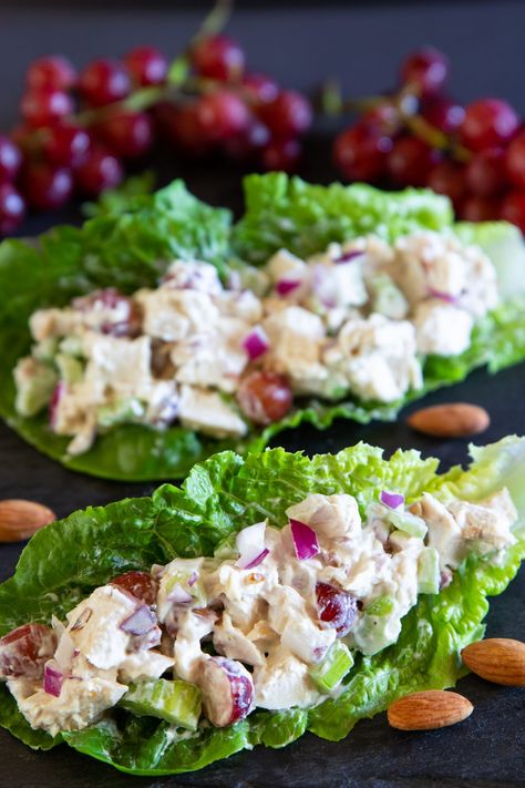 a close up image of creamy chicken salad inside of a romaine lettuce leaf with red grapes in the background Low Calorie Chicken Salad, Romaine Lettuce Recipe, Easy Chicken Lettuce Wraps, Lettuce Wraps Healthy, Lettuce Wraps Recipe, Lettuce Recipes, Chicken Salad With Grapes, Chicken Lettuce Wraps Recipe, Chicken Salad Lettuce