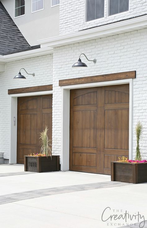 Painted brick exterior with wood tone garage doors. #garage #paint Painted Brick Exterior, Painted Brick Exteriors, Garage Paint, Garage Door Styles, Building Inspiration, Garage Exterior, Wood Garage Doors, Garage Door Makeover, Garage Door Design