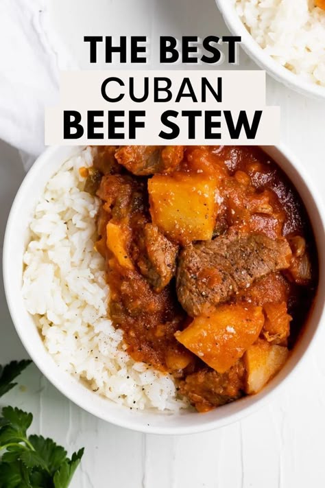 An overhead shot of carne con papas on white rice in a white bowl with the words "the best cuban beef stew" in the foreground