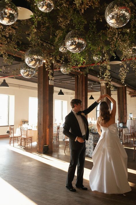 Couples first dance under a greenery and disco ball installation at The Liberty Warehouse Disco Balls Wedding, Ceiling Greenery, Reception Ceiling, Organic Modern Decor Kitchen, Modern Decor Kitchen, Wedding Ceiling, Dance Floor Wedding, Nye Wedding, Warehouse Wedding