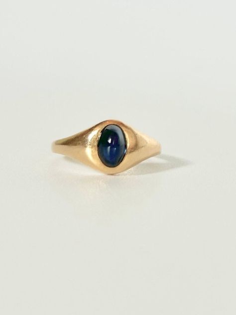 Vintage Art Deco Sapphire Cabochon in 18k Yellow Gold Ring. This vintage yellow gold sapphire cabochon ring is made with 18k gold and contains one stunning Sapphire in a beautiful medium/deep Blue color, placed in a four prong setting. The band feels very sturdy and comfortable to wear every day.  MARKINGS AND HISTORY: 18K marked on the outside of the band SIZE: 6 ERA: Most likely vintage from the 1940's. OVERALL CONDITION: Minor scuffs on the band but overall beautiful vintage condition GEMSTONES: 1 high-domed oval medium/deep Blue Sapphire cabochon. measuring approx. 6mm Long x 4mm Wide x 3mm Deep. Blue Gold Ring, Vintage Bezel Engagement Ring, Thick Band Engagement Ring Gold, Art Deco 14k Gold Cabochon Ring, East West Oval Ring, Vintage Gold Sapphire Cabochon Ring, Vintage Blue Cabochon Ring, Sapphire Cabochon Ring, 14k Gold Cabochon Sapphire Ring