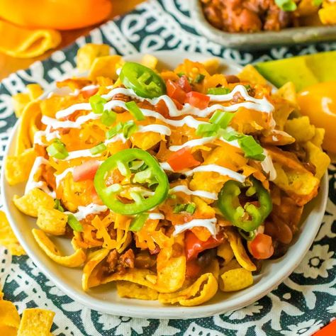 Easy Crock Pot Frito Chili Pie is soul-warming comfort food that is made with slow-cooked beefy chili, crunchy Fritos corn chips, and melted cheese served over more crunchy Fritos. This hearty recipe is so easy to make using simple ingredients, serves a dinner crowd, and is a fan favorite no matter the occasion! | www.persnicketyplates.com Split Pea Soup Crockpot, Frito Chili, Frito Chili Pie, Chili Pie, Slow Cooker Steak, Slow Cooker Meatloaf, Frito Pie, Slow Cooker Meatballs, Crockpot Chili