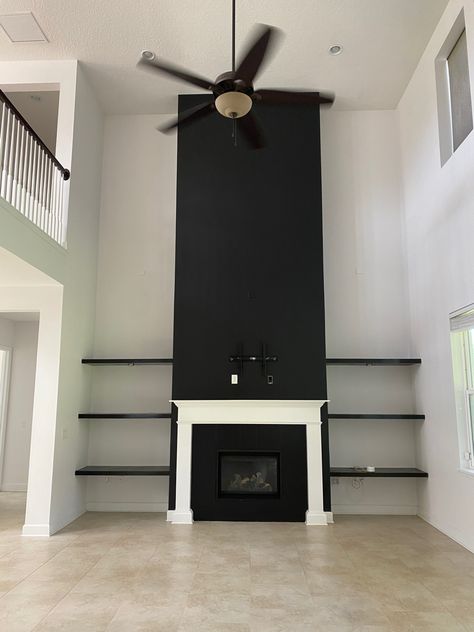 Black Wainscoting Fireplace Wall, White And Black Marble Fireplace, Tall Fireplace Wall High Ceilings Black, Tall Black Fireplace Wall High Ceilings, Black Marble Wall Fireplace, Black Marble Tile Fireplace Surround, Accent Wall Fireplace, Black Fireplace Wsll, Rental Interior