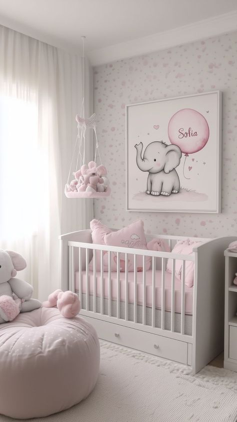 A baby girl's nursery with a white crib, pink bedding, and a large elephant-themed wall art personalized with "Sofia." The room features a hanging basket of plush toys, soft white curtains, and a cozy pink bean bag chair. Toddler Room Inspiration, Pink Elephant Nursery, Elephant Nursery Girl, Pink Nursery Ideas, Nursery Inspiration Girl, Playroom Decor Ideas, Adorable Stuffed Animals, Elephant Nursery Decor