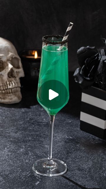 Sarah Gualtieri on Instagram: "My Beetlejuice Margarita was so popular I thought it would be fun to make another Beetlejuice cocktail. I wasn’t quite sure what to call this one - anyone have a better name?

Beetlejuice Bubbles

3 oz sparkling wine
1 oz limoncello
½ oz blue curacao
Dash of green edible glitter (optional)
Rim: agave and black sugar 

#cocktails #beetlejuice #halloweenrecipes #halloween"