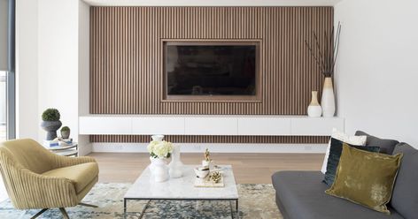 RZ INTERIORS have designed a contemporary and minimal wood slat accent wall for this family room, that would help to achieve a simplified sense of calm. Timber Tv Feature Wall, Timber Tv Wall, Timber Slat Tv Wall, Tv Wall Wood Slats, Timber Slat Feature Wall, Tv Feature Wall With Storage, Tv Surround, Room Pinterest, White Walls Living Room