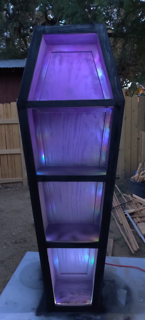 With lights Coffin Bookshelf Diy Plans, Dark Purple Room Ideas Bedrooms, Coffin Shelf Diy Plans, Wednesday Room, Coffin Furniture, Horror Living Room, Dark Purple Room, Gothic Room Ideas, Coffin Bookcase