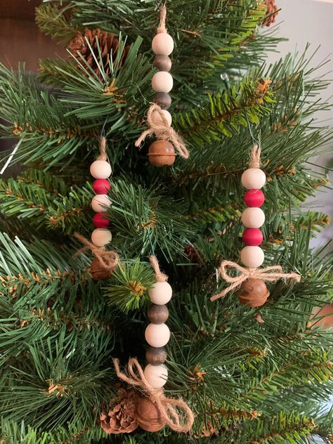 Thanks for stopping by! You're viewing one of my handmade sets of Christmas ornaments. Each ornament is made with 5 wooden beads and 1 "antique" bell. The beads can be colored with a dark brown stain, red or green dye or left natural.  Twine is used to string the ornament and a small loop is left at the top for hanging with a hook. Each ornament measures just over 3" tall plus ~.5" loop. Default bead colors are as shown in picture, i.e. 3 natural color beads with 2 colored beads mixed in (select the colored bead option in the Primary Color list). If you prefer a different mix of bead colors please be sure to include instructions in the Personalization section. I'll make every attempt to satisfy your request. Please note that each ornament is handmade and made to order. Please be aware that Beaded Christmas Decorations, Antique Bell, Beaded Christmas Ornaments, Christmas Bead, Wooden Christmas Ornaments, Color Beads, Christmas Ornaments Homemade, Christmas Ornament Crafts, Handmade Christmas Ornaments