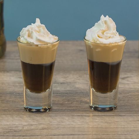 BANANA BREAD SHOOTER 3/4 oz. (22.5ml) Chocolate Liqueur 3/4 oz. (22.5ml) Banana Liqueur 1/2 oz. (15ml) Irish Cream Garnish: Whipped Cream PREPARATION 1. Add ice, chocolate liqueur and banana liqueur to shaking glass and combine well. Pour into shot glass. 2. Use a spoon to gently layer irish cream on top before finishing with whipped cream. DRINK RESPONSIBLY! (User Submitted by Brandon @ TipsyBartender.com) Holiday Shot Recipes, Amaretto Recipes, Tipsy Bartender Recipes, Drinking Shots, Layered Shots, Baileys Cocktails, Shooter Recipes, Bachelorette Party Drinks, Dessert Shots