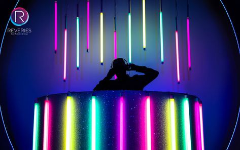 Custom made glittered curved DJ Booth with multi coloured neon encapsulate tubes for themed corporate party. #neonparty #ibizavibes #partydesign #eventdesign #setdesign #djbooth #events #reveriesevents Neon Dj Booth, Led Dj Booth, Cool Dj Booth, Festival Dj Booth, Futuristic Party Theme, Dj Booth Design, Dj Booth Ideas, Futuristic Party, Dj Table