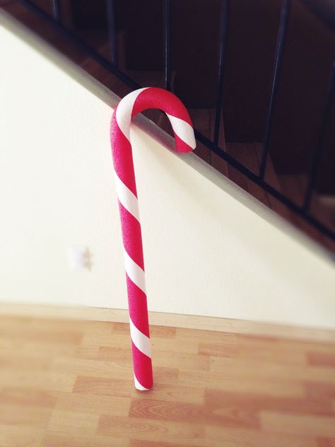 Giant candy canes I made out of red pool noodles, white duck tape and wire hangers. Bend the hangers after you put them inside the noodle. Pool Noodle Candy Cane, How To Make Candy Canes Out Of Pool Noodles, Candy Cane Pool Noodle Diy Christmas, Pool Noodle Peppermint Candy, Large Candy Cane Decorations, Giant Candy Cane, Candy Cane Decorations, Canes Decor, Giant Candy